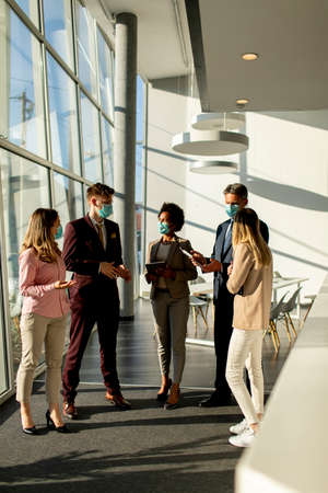 Group of business people meeting and working in the office and wear mask for protect prevent...