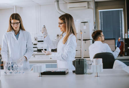 Cute female researchers in white lab coat working in the laboratoryの写真素材