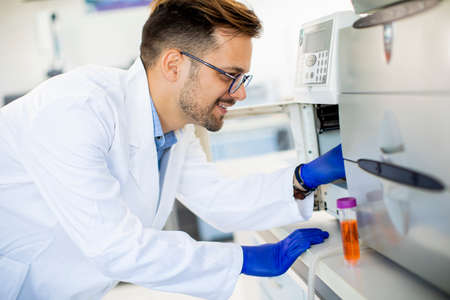 Young researcher working with laboratory equipment