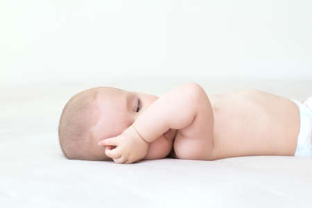 Cute adorable baby girl lying on the bed