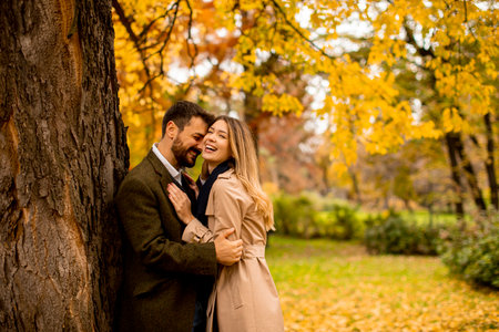 Handsome young couple in the autumn park