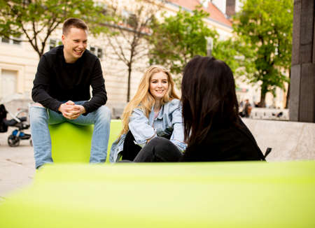 Group of young people sitting on the lounge seats in Vienna, Austria
