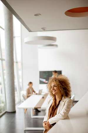 Young African American businesswoman standing in the modern officeの写真素材