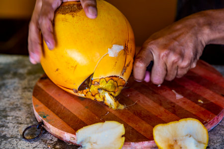 View at preparing of a coconut for drinking on a Hikkaduwa market at Sri Lankaの写真素材