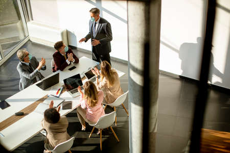 Aerial view at multiethnic group of business people working together and preparing new project on a meeting in the officeの写真素材