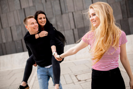 Group of young people having fun outdoors on a city street