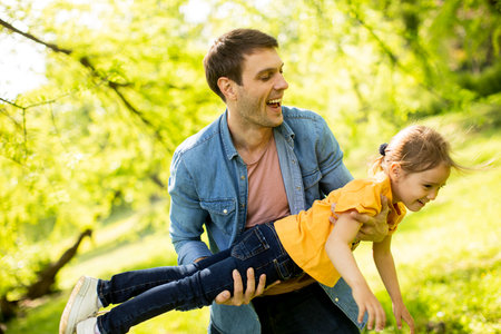 Single father having fun in the park with cute little daughterの写真素材