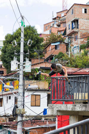MEDELLIN, COLOMBIA - SEPTEMBER 12, 2019: Unidentified man at Comuna 13 in Medellin, Colombia. Once known as Colombias most dangerous barrio, today graffiti tour is one of the most popular tourist attractions in Medellin.のeditorial素材