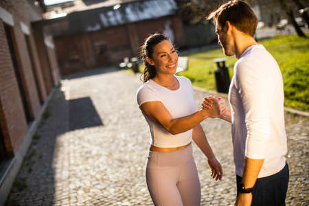 Sporty young woman having training exercise with her personal trainerの写真素材