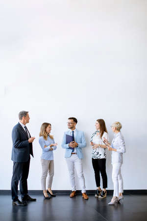 Group of business people standing by the wall in the officeの写真素材