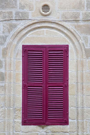 Traidtional purple shutters on the window at Gozo, Maltaの写真素材
