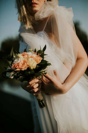 Cute young bride with flower bouquetの写真素材