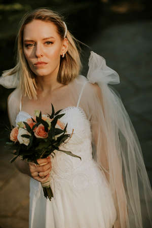 Cute young bride with flower bouquetの写真素材