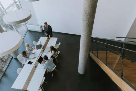 Aerial view at group of business people working together and preparing new project on a meeting in the officeの写真素材