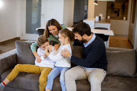 Cute siblings fighting over TV remote control at home