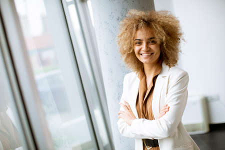 Young African American businesswoman standing in the modern officeの写真素材