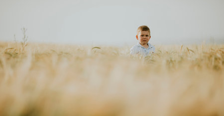 Scared little boy in the summer fieldの写真素材