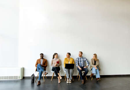 Group of bored young people waiting for the job interviewの写真素材