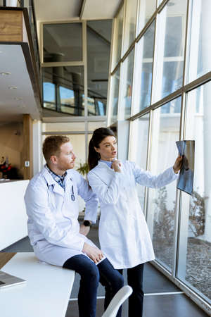 Team of doctors examining x-ray image in the office