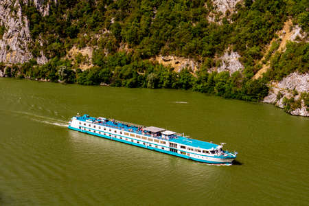 Djerdap, Serbia - September 2, 2021: Cruise ship on river Danube in Djerdap gorge in Serbia. At 2016...