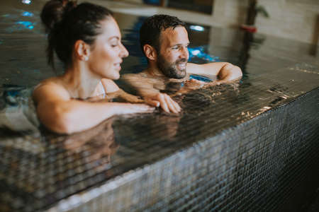 Handsome youple relaxing in a indoor swimming pool