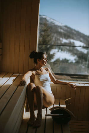 Attractive young woman relaxing in the saunaの写真素材