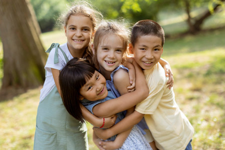 Group of cute asian and caucasian kids having fun in the park