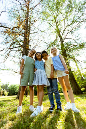 Group of cute asian and caucasian kids having fun in the park