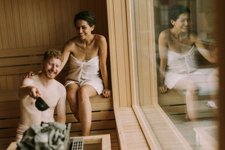 Handsome young couple relaxing in the saunaの写真素材