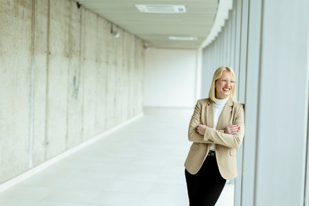 Young business woman standing in the office corridorの写真素材