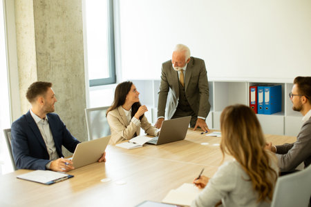 Group of businessmen and businesswomen working together in officeの写真素材