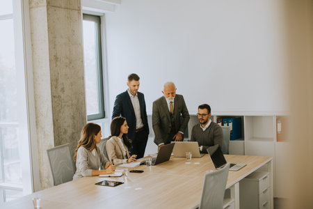 Group of businessmen and businesswomen working together in officeの写真素材