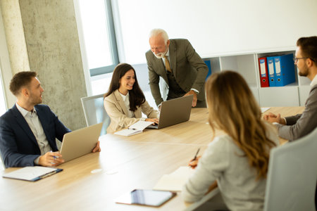 Group of businessmen and businesswomen working together in office