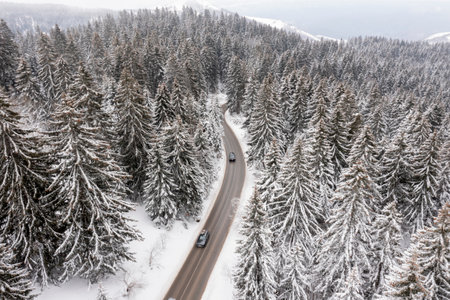Drone view at mountain road at snowy winterの写真素材