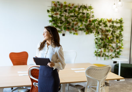 Young business woman with digital tablet standing in the modern officeの写真素材