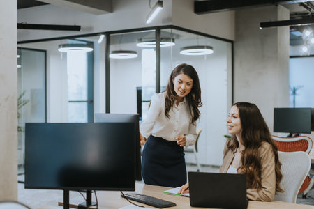 Young business women discussing in the modern officeの写真素材
