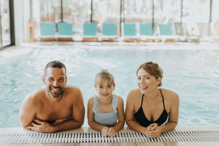 Family enjoy in the indoor swimming poolの写真素材