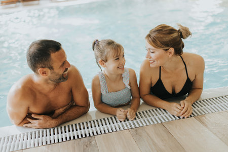 Family enjoy in the indoor swimming poolの写真素材