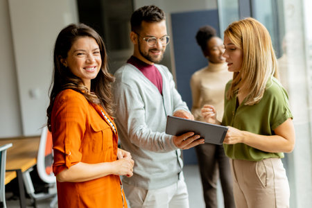 Young business woman woman standing in front of her team at the modern officeの写真素材