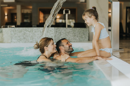 Family enjoy in the indoor swimming poolの写真素材
