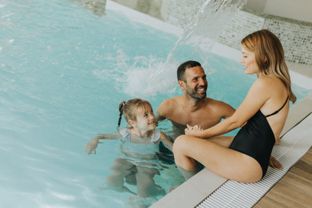 Family enjoy in the indoor swimming poolの写真素材