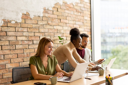Young multiethnic startup team working by the brick wall in industrial style officeの写真素材