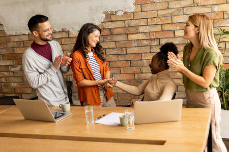 Young multiethnic startup team working by the brick wall in industrial style officeの写真素材