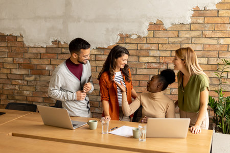 Young multiethnic startup team working by the brick wall in industrial style officeの写真素材