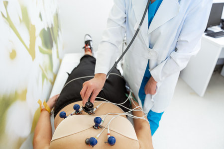 A patient relaxes while a medical professional carefully administers an ECG test.の写真素材