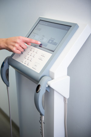 A healthcare professional calibrates advanced medical equipment.の写真素材