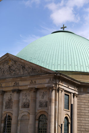 St. Hedwig's Cathedral stands majestically in Berlin, showcasing its stunning dome and intricate designs, surrounded by the rich history of the cityの写真素材