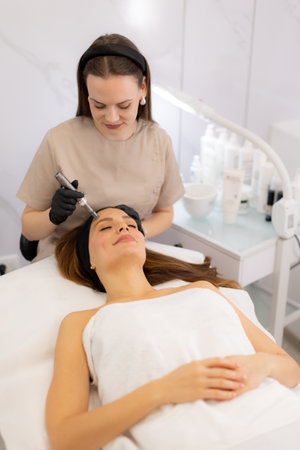 A skilled practitioner performs microneedling on a relaxed client, enhancing skin texture and...
