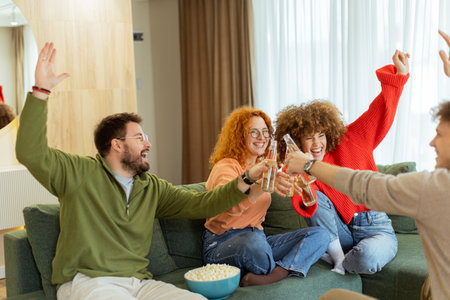 Laughter fills the spacious living room as friends raise their drinks high, reveling in the delightful moments of shared joy. Soft lighting adds warmth to the cozy atmosphere.の写真素材