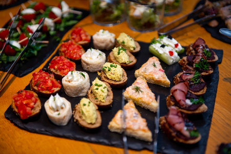 An array of beautifully crafted canapes awaits guests at a lively evening gathering, featuring fresh ingredients and artistic presentation to tantalize the taste buds.の写真素材
